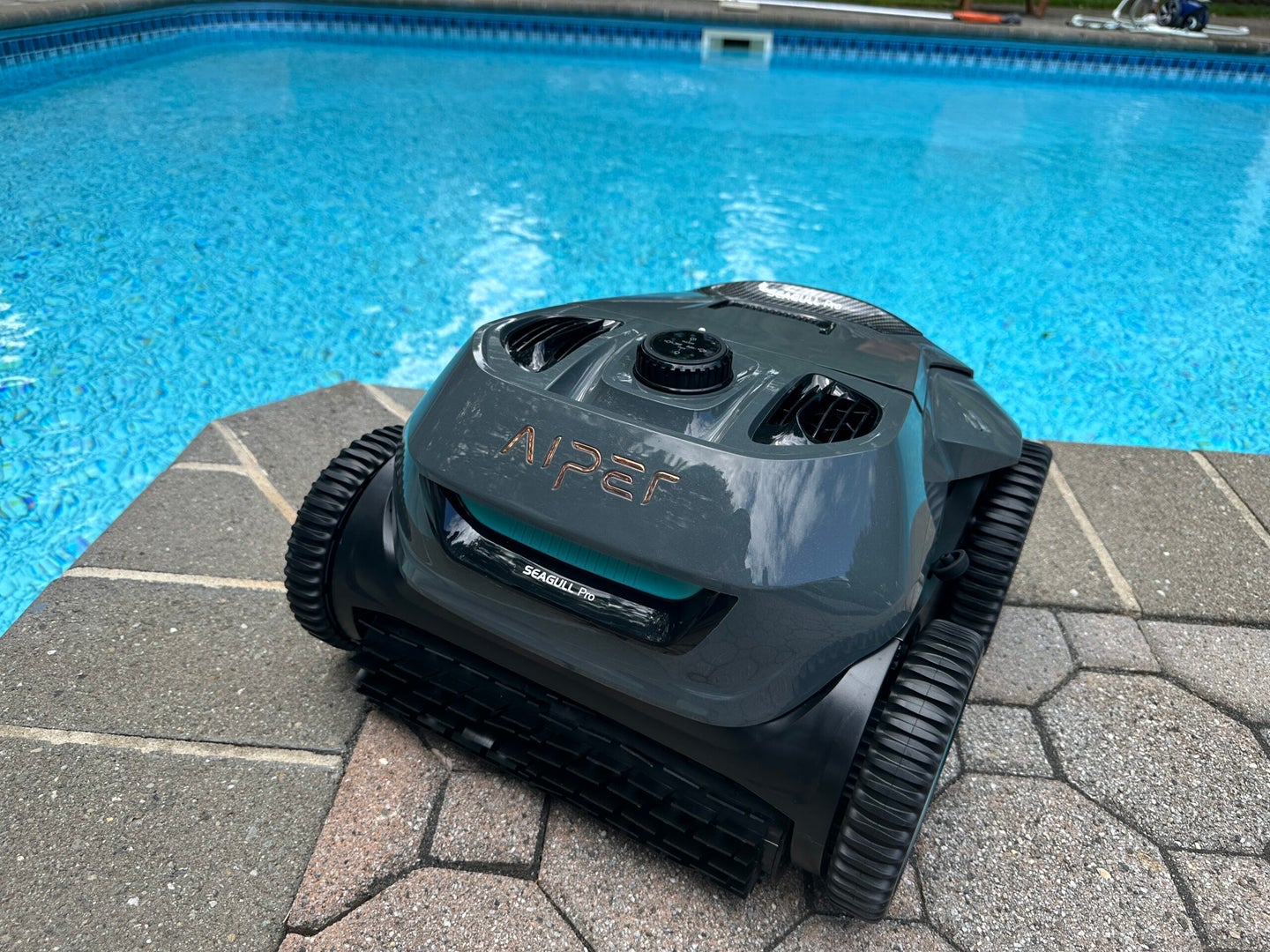 Aiper Seagull Pro Pool Vacuum next to a pool